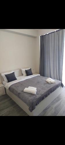 a bedroom with a large bed with two towels on it at Alvina complex in Tsaghkadzor