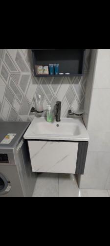a white sink in a bathroom with a wall at Alvina complex in Tsaghkadzor
