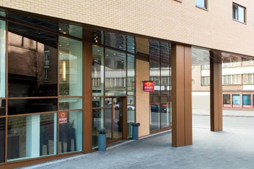 an office building with glass windows and a building at Aparthotel Adagio Birmingham City Centre in Birmingham