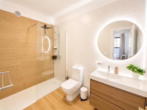 a bathroom with a toilet and a sink and a mirror at Holiday in Playa Calera - Swimming pool in Valle Gran Rey