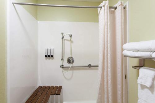 a bathroom with a shower with a shower curtain at Baymont by Wyndham Dale in Dale