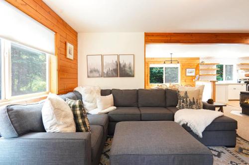 a living room with a couch and a table at Wandering Rivers Retreat in Glacier
