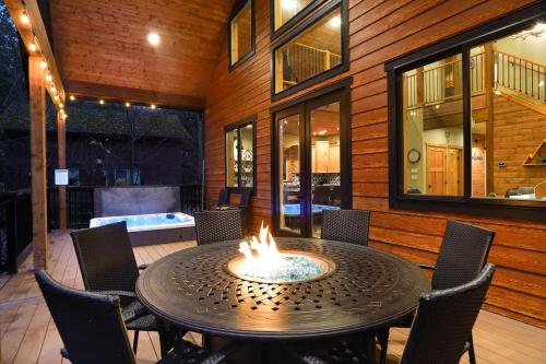 a fire pit in the middle of a table with chairs at Cottonwood Cabin in Glacier