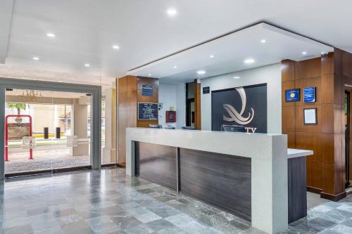 a lobby with a reception counter in a building at Quality Inn Piedras Negras in Piedras Negras