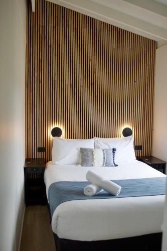 a bedroom with a large bed with white pillows at BIG4 Wilsons Prom Holiday Park in Yanakie