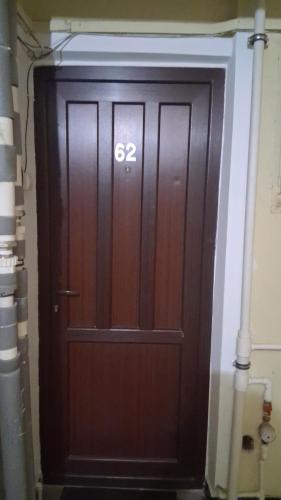 a large wooden door with the number on it at Apartament Antonia&Alex in Brad