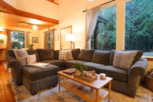 a living room with a couch and a table at Heliotrope Haus in Glacier