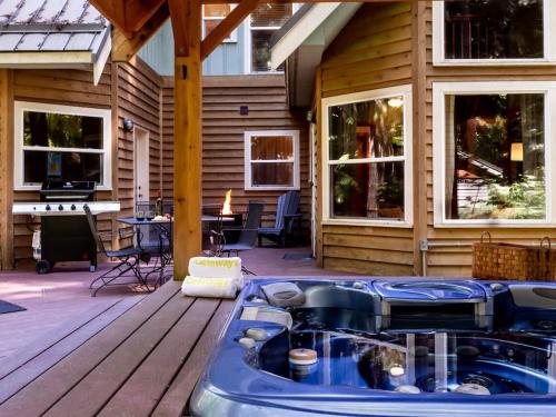 a jacuzzi tub on the deck of a house at Heliotrope Haus in Glacier