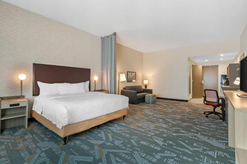 a hotel room with a bed and a living room at Home2 Suites By Hilton Somerset, Ky in Somerset
