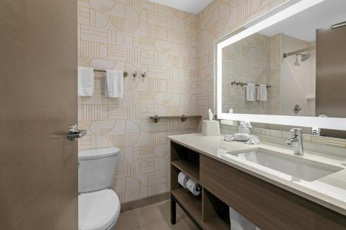 a bathroom with a toilet and a sink and a mirror at Home2 Suites By Hilton Somerset, Ky in Somerset