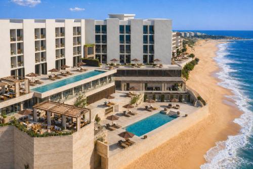 an aerial view of the hotel and the beach at Casa de Sada Algarve Beach Resort, Curio Collection by Hilton in Armação de Pêra