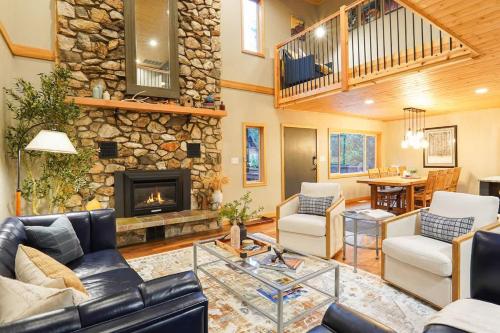 a living room with a couch and a fireplace at Silver Peak Lodge in Glacier