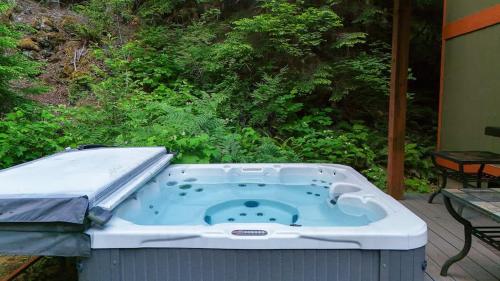 a hot tub sitting on top of a patio at Silver Peak Lodge in Glacier