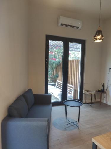 a living room with a couch and a table at Mini Condos 2 Studio-Loft with garden in Mrčevac