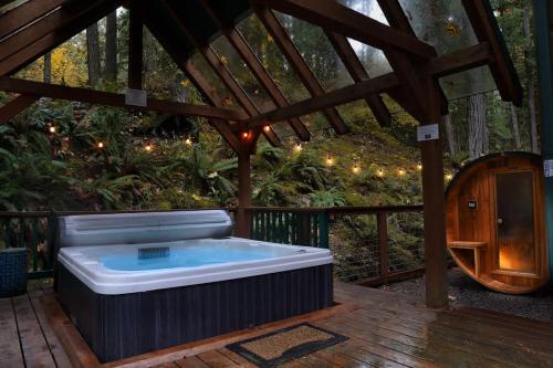 a hot tub in a gazebo on a deck at Snowline Grand Lodge in Glacier