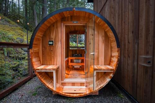 a wooden circular sauna with two benches in it at Snowline Grand Lodge in Glacier