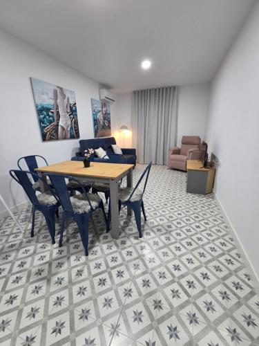 a living room with a table and chairs and a couch at LAS CASITAS DE JISA in Talavera de la Reina