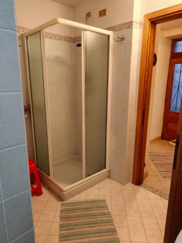 a shower with a glass door in a bathroom at Casa MEME' in Santa Maria Maggiore