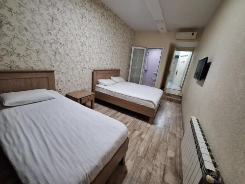a hotel room with two beds and a tv at Baku apart in Baku