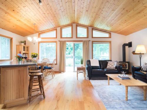 a living room with a couch and a table at Woodland Bungalow in Glacier