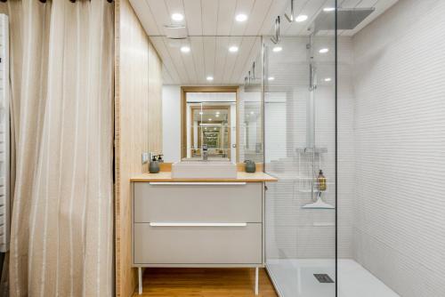 a bathroom with a sink and a shower at Villa 52 Naturiste in Cap d'Agde