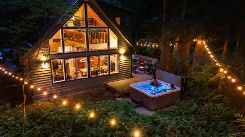 an aerial view of a house at night with a hot tub at Yverin Muse Cabin in Glacier