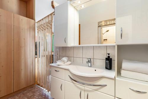 a bathroom with a sink and a mirror at Pferdeblick Hütte auf der Rodeoranc in Rottenmann