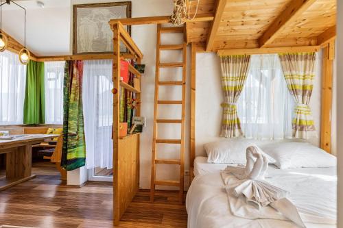 a bedroom with a bunk bed and a ladder at Pferdeblick Hütte auf der Rodeoranc in Rottenmann