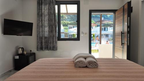 a bedroom with a bed with towels on it at Arsuz Suite House in Arsuz