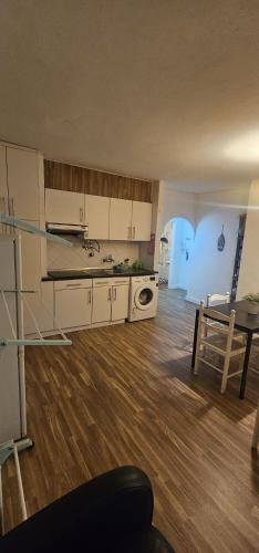 a kitchen and dining room with a table and a kitchen and a dining room at studio world romer in Costa da Caparica