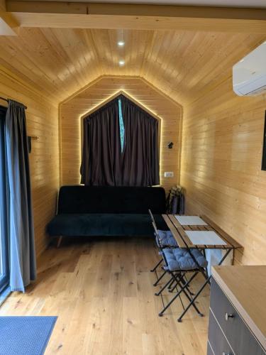 a living room with a couch and a table at Rosemont Retreat by Tiny Away in Bessé-sur-Braye