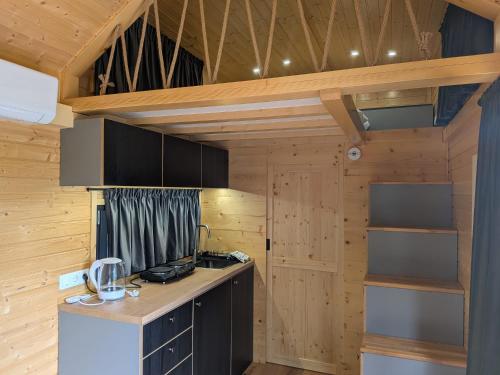 a kitchen with wooden walls and a counter top at Rosemont Retreat by Tiny Away in Bessé-sur-Braye