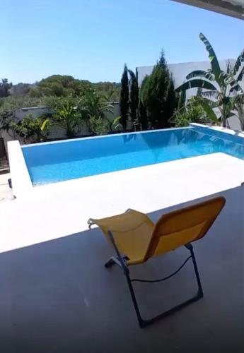 a yellow chair sitting next to a swimming pool at Hammamet sunrise in Hammamet