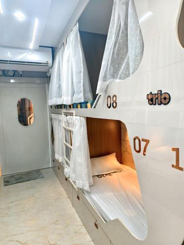 a room with two bunk beds in a ship at Trio Rooms & dormitory in Trivandrum