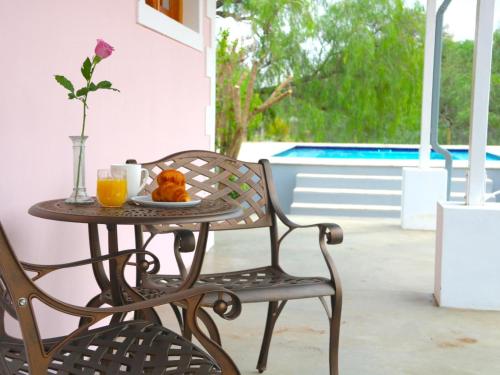 a table with a plate of food and two glasses of orange juice at Maskam Manor in Vanrhynsdorp