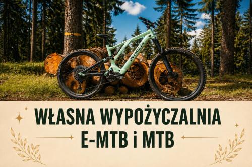 a mountain bike parked next to a sign at Willa Marianna in Lądek-Zdrój