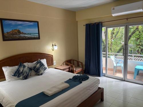 a bedroom with a bed with a view of a balcony at Lalisa Hotel Aonang in Ao Nang Beach