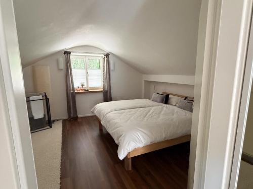 a bedroom with a large bed and a window at Haus am Bach in Roitham