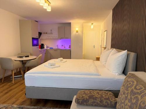 a hotel room with a large bed and a kitchen at Lorez 5A by Arosa Holiday in Arosa
