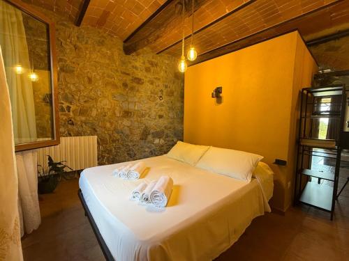 a bedroom with a bed with two towels on it at Domus Olea BnB in Roccatederighi
