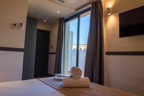 a room with a bed with a view of a window at May Ramblas Hotel in Barcelona