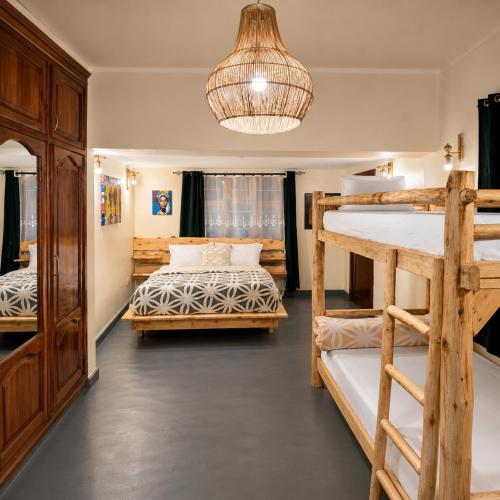 a room with two bunk beds and a chandelier at Hakuna matata villas & hostels in Arusha