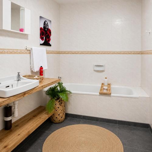 a bathroom with a sink and a bath tub at Hakuna matata villas & hostels in Arusha