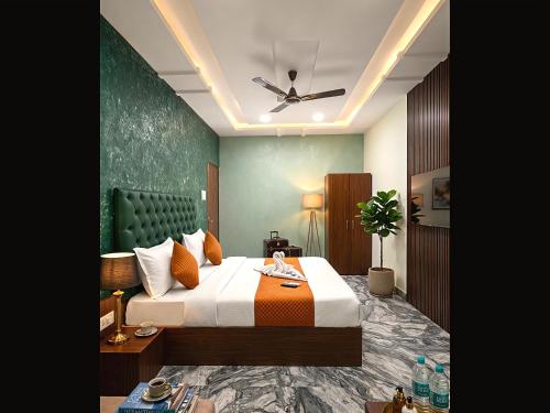 a bedroom with a bed and a ceiling fan at Hotel Prime Access Inn in Indore