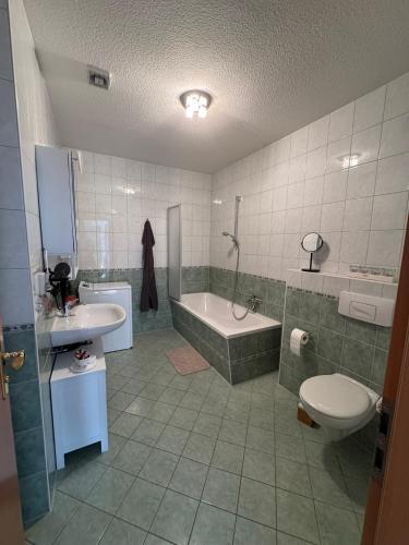 a bathroom with a tub and a toilet and a sink at ErzNest in Thum