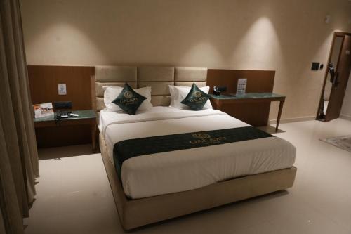 a bedroom with a large bed in a room at Galaxy Air Suites in Bangalore