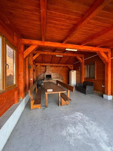 a large room with a table and benches in it at Cabana LUCI - FIGA in Beclean