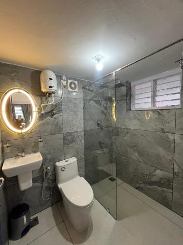 a bathroom with a toilet and a sink and a shower at Avanthi Homestay in Varkala