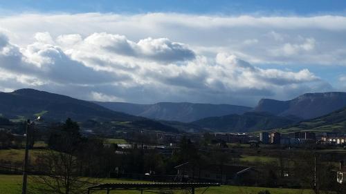 a view of a valley with mountains and clouds at Saiaritz in Amurrio