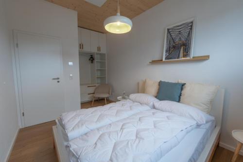 a bedroom with a large white bed in a room at Casa CaVi Bergheider See in Buschmühle
